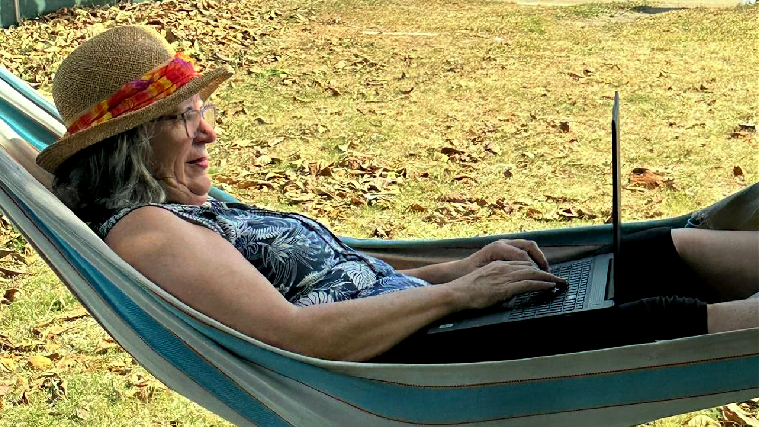 Elizabeth working on her laptop in a hammock on her solo retreat in Panama