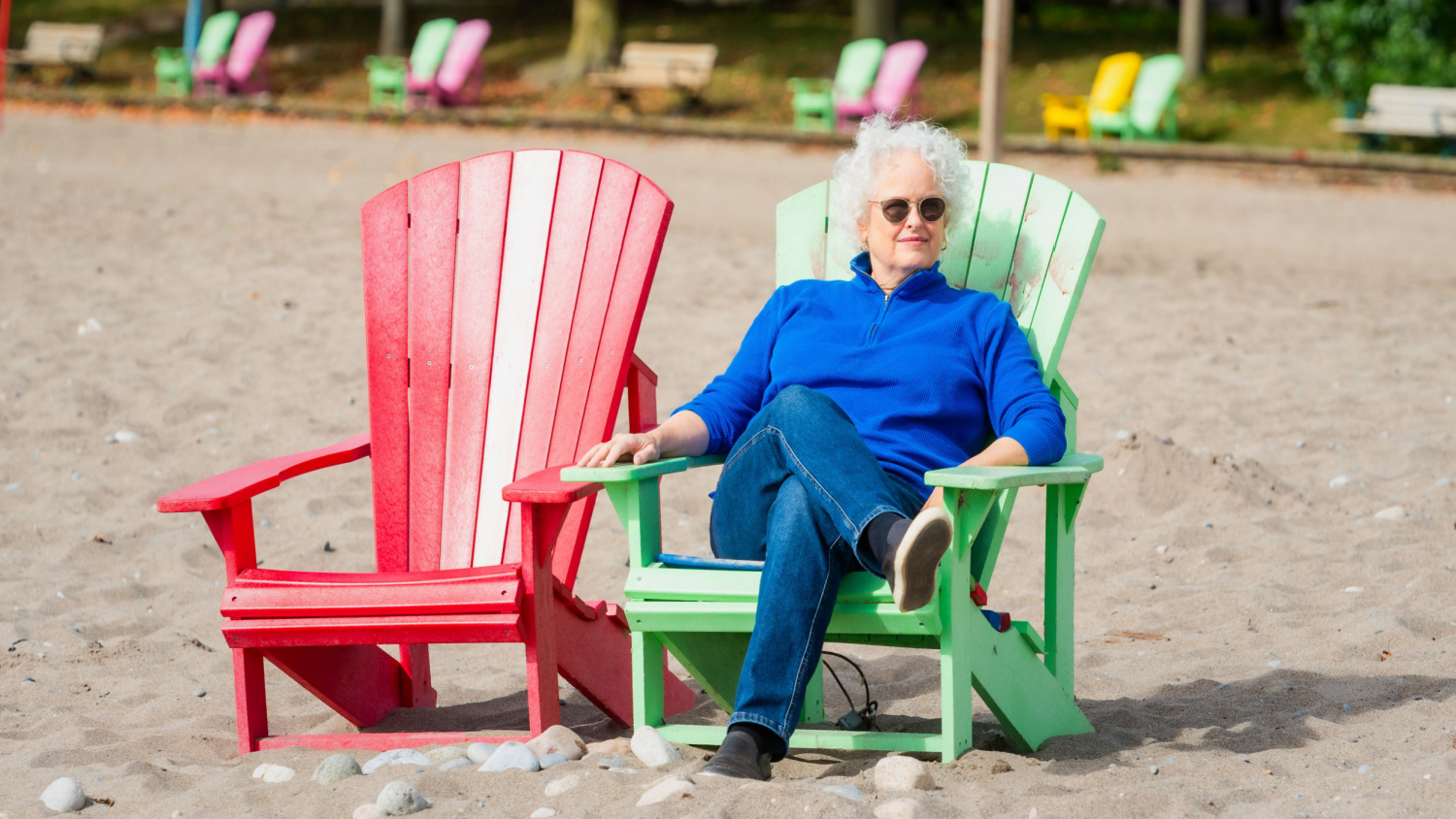 Janice Waugh sitting in a muskoka chair. She has worked hard to deliver trips with no single supplement.