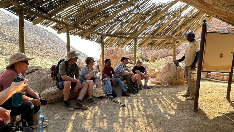 image, guide giving talk, white lady rock namibia,