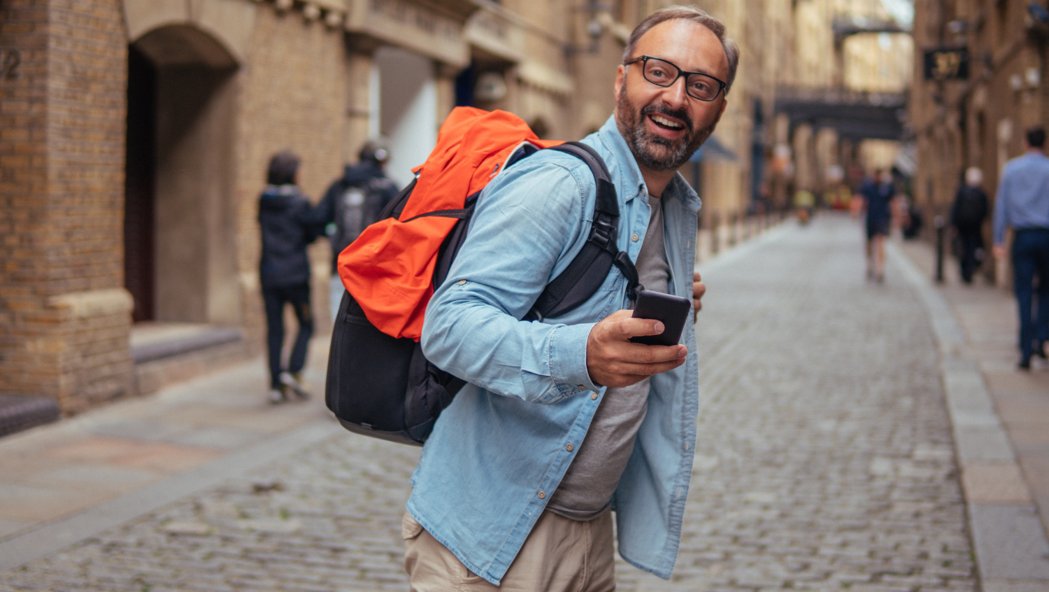 man traveling alone with smartphone in hand